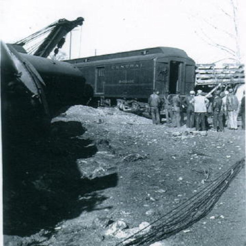 Group of men checking out railroad car.